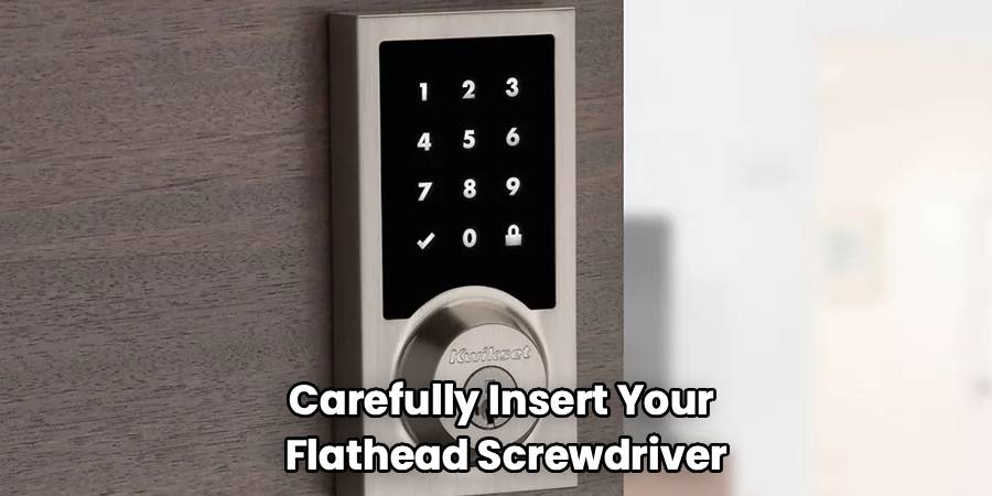 Carefully Insert Your
Flathead Screwdriver