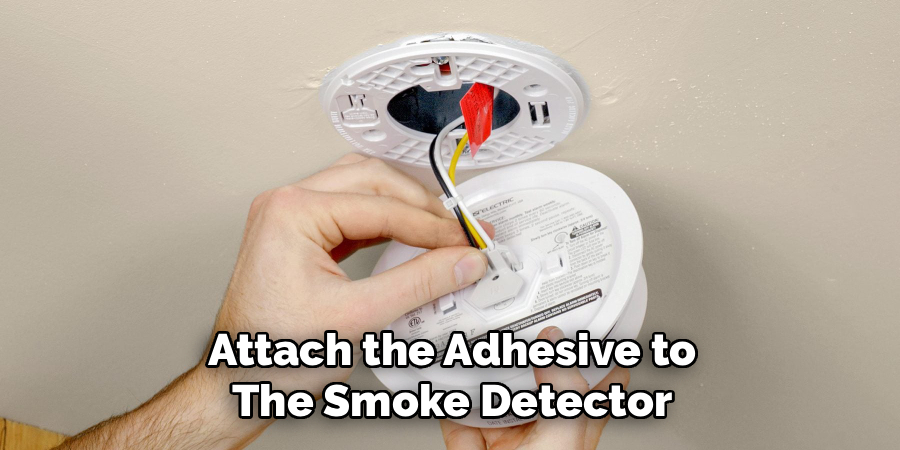 Attach the Adhesive to the Smoke Detector